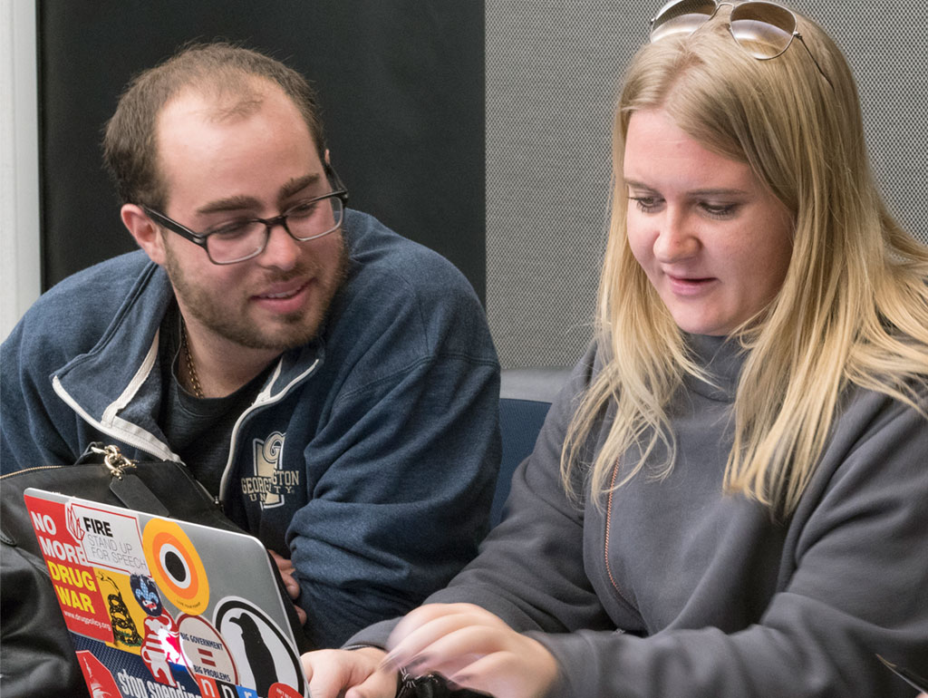 Male and Female Student working on a laptop