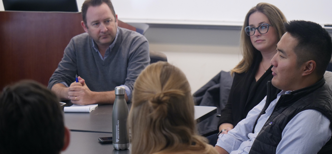 Students sitting around a conference table in discussion