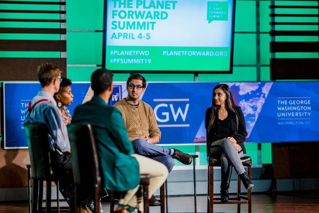 Panel on stage at the Planet Forward Summit in 2019